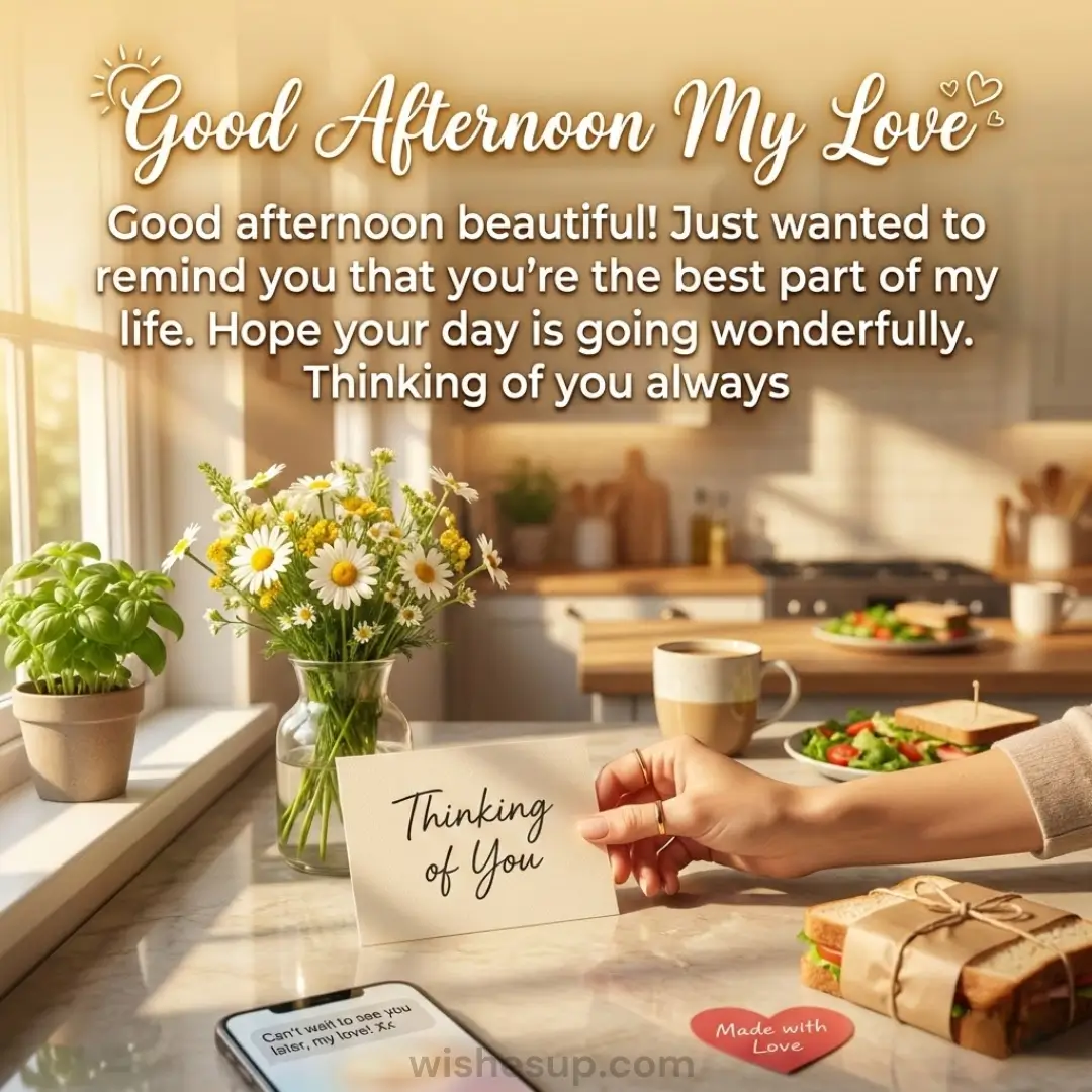 Golden afternoon light bathes a marble counter as a hand holds a "Thinking of You" note beside fresh daisies and a wrapped sandwich. This cozy kitchen scene glows with warm hues, vibrant greenery, and romantic text.