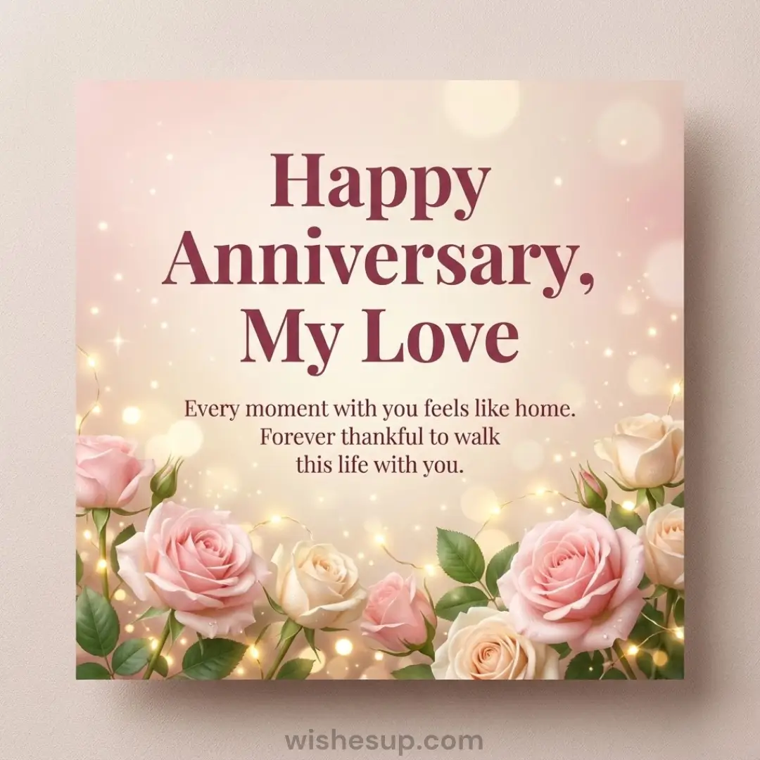 Dewy pink and cream roses are illuminated by twinkling fairy lights on this romantic card. Elegant maroon typography reads 'Happy Anniversary, My Love' against a warm, shimmering peach bokeh background filled with golden sparkles.